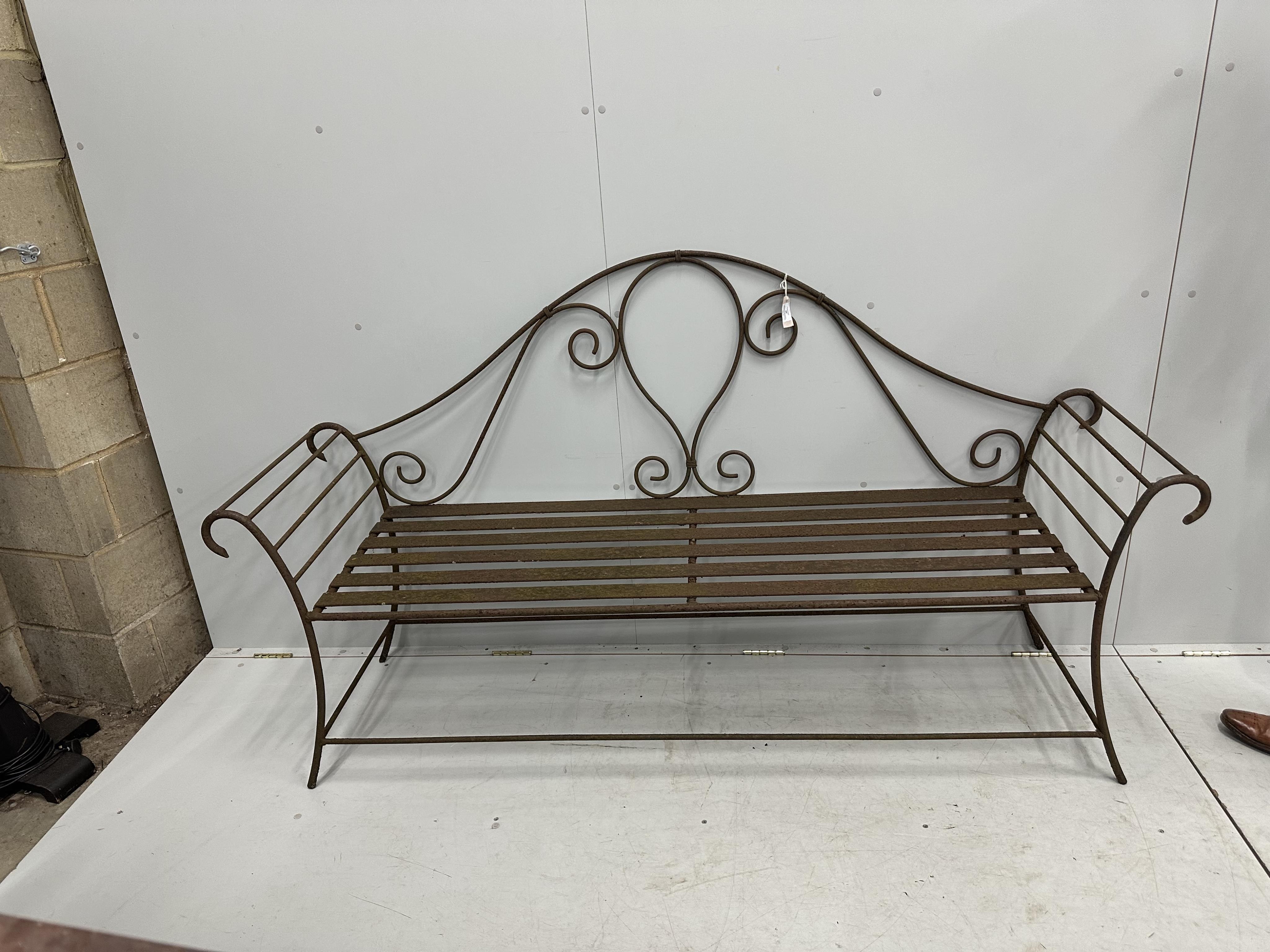 A pair of wrought iron garden benches, width 184cm, height 102cm. Condition - fair